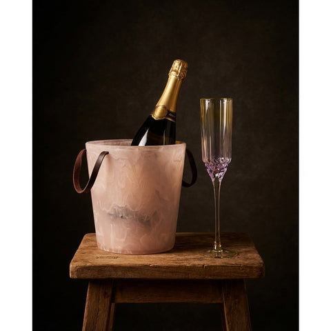 Secchiello per il ghiaccio in resina marmorizzata rosa e bianco con maniglie integrate 23 cm contenente ghiaccio e una bottiglia di vino su un tavolo da pranzo