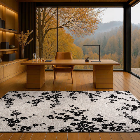 Tappeto floreale nero con dettagli petalo chiari Night Snow Sakura di Louis De Poortere posizionato al centro di un soggiorno moderno con arredi in legno chiaro
