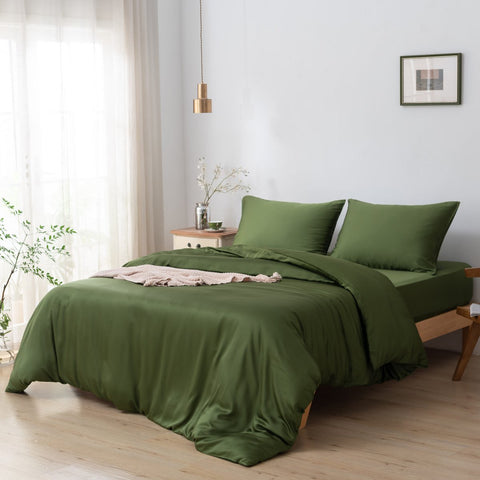 A Deep Moss Boomba Bamboo® double duvet cover made of 100% bamboo, draped over a bed with matching pillows in a bedroom bathed in natural light